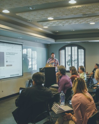 Researcher presenting to an audience in a seminar room